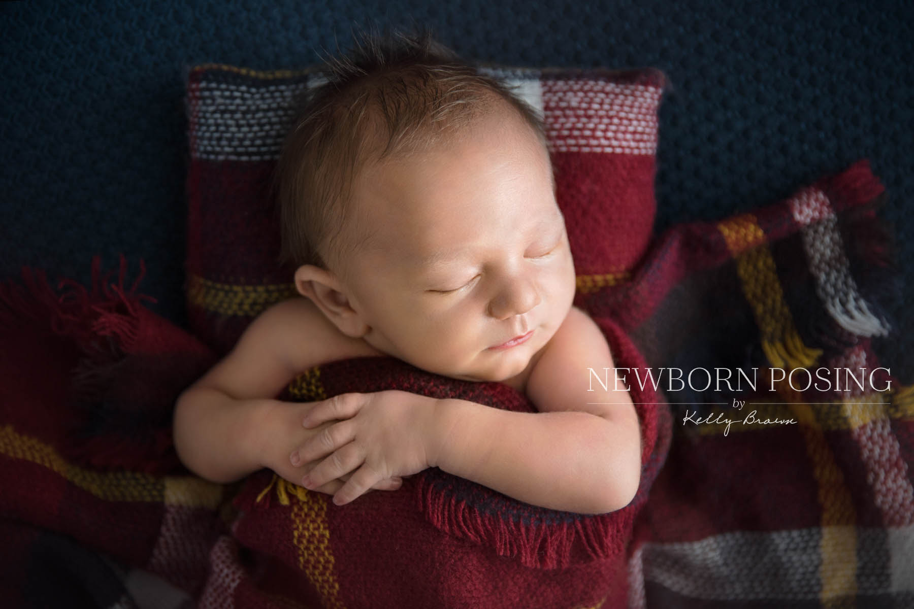 Newborn photography of baby lying on back in a bed