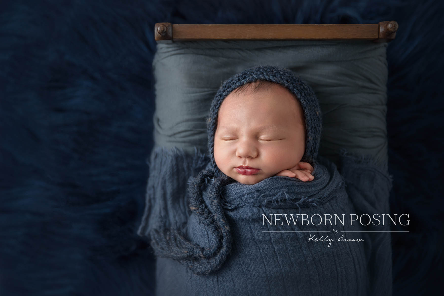 Newborn photography by Kelly Brown photo of baby in a bed