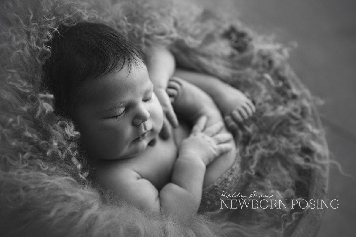 Newborn in wooden bowl. Choosing newborn photography props - Kelly Brown
